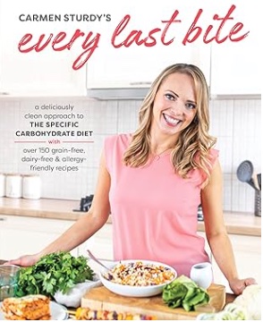 Cover of 'Every Last Bite' by Carmen Sturdy, featuring a smiling woman in a pink shirt standing in a kitchen with a variety of healthy dishes displayed on the counter.